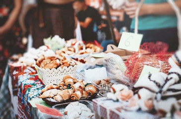 Homemade sweet pastries for sale.Variety of homemade puff pastry buns cinnamon rolls and croissant. Food festival. Street trading.