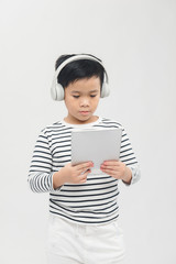 Little boy is concentrated gaming with digital tablet