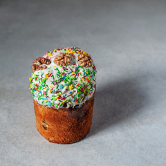 Beautiful Easter cake on a gray background. Sweet pastries decorated with nuts. Selective focus
