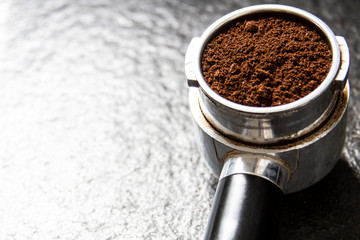 Filter holder for espresso coffee machine with coffee powder in detail. Italian espresso and fresh...