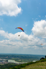 Outdoor city green hill scenery and paragliding