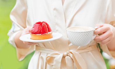 Sweet morning, cake with strawberry and cup of coffee