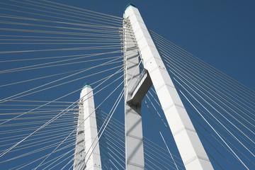 Cable-stayed road bridge against the blue sky, beautiful engineering solutions