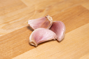 Cloves of garlic on natural wooden table