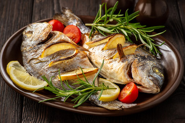 Grilled gilt-head bream  with lemon. and rosemary. 