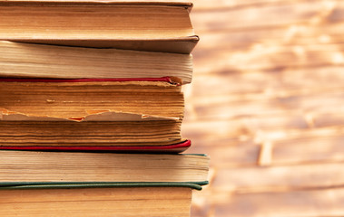stack of old books on wooden background