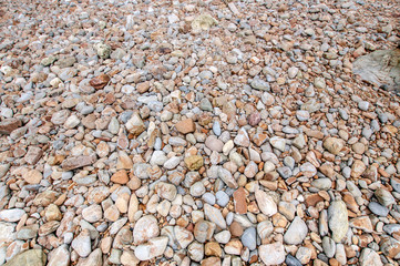 Pattern background of pebble on the beach closeup