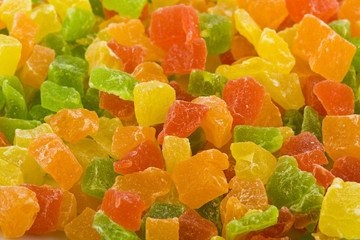 Candied colorful (red, yellow, orange and green) fruits as background.