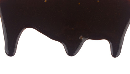 Pouring liquid chocolate Isolated on a white background close-up.