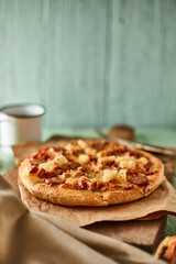 Pizza with bacon and sausage.