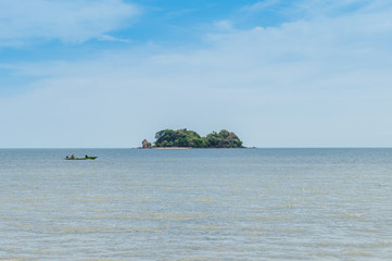 Closeup of island with boat on the ocean
