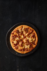 Pizza with bacon and sausage.