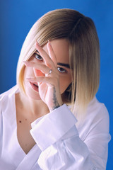 Close up portrait beautiful girl with fashion makeup and nails posing at studio over dark background