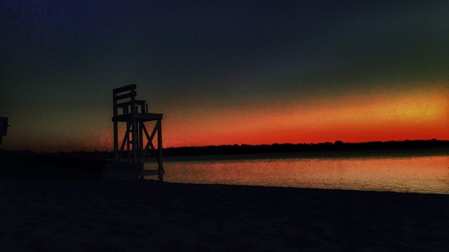 Silhouette Of Lifeguard Chair At Sunset