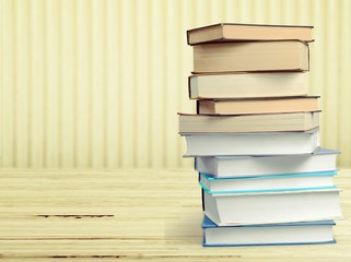 Stack of old study books on the wooden desk