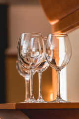 Empty wine glasses on the wooden table, reflection in the glass