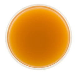 Glass of juice isolated on a white background close-up. The view from the top.
