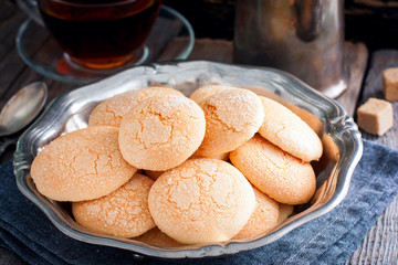 Homemade sugar cookies with craquelure crust in a metal vase, selective focus