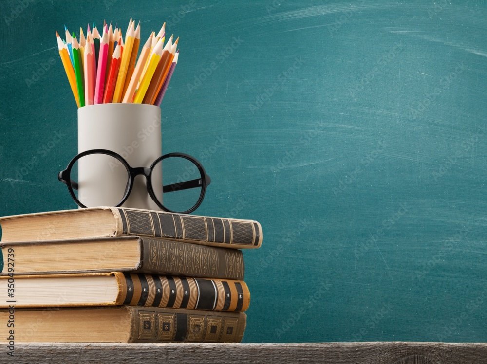 Poster study books and supplies on the desk on the blackboard background