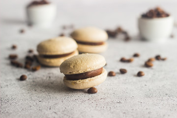 Macaroons. Delicious french desserts. Macaroons with coffee beans and chocolate. Macaroons on the table