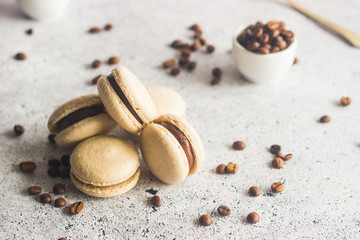 Macaroons. Delicious french desserts. Macaroons with coffee beans and chocolate. Macaroons on the table