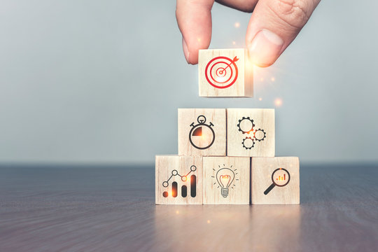 Hand arranging wood block stacking as step stair on table. Successful business steps, Business development Decide and choose concept.The left space for your content.