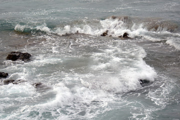 small foam at the rocks after the waves