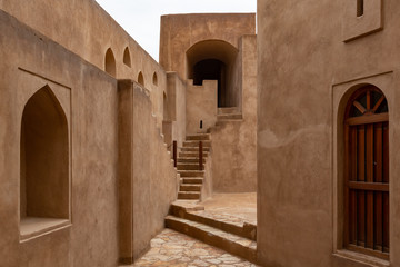 Fototapeta na wymiar Patio of Jibreen Castle, Oman with stairs, doors and other achitectutals elements