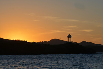 sunset on the coast, with small hills