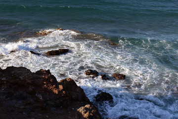 foam next to the rocky shore