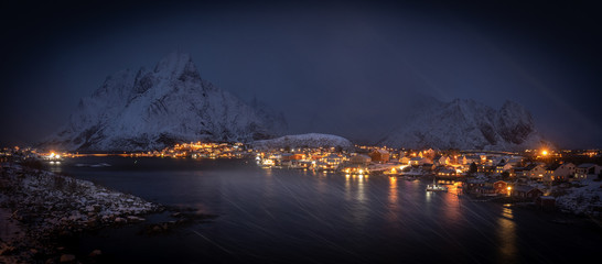 Night panorama of Reine, Lofoten in snowstorm