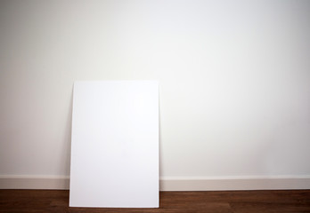 Blank canvas,poster or board against white wall on pvc floor in modern interior, empty room space for text