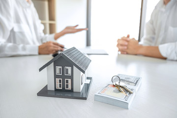 Real estate broker agent presenting and consult to customer to decision making sign insurance form...