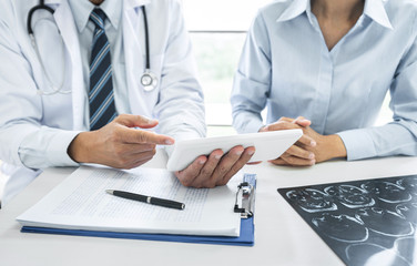 Fototapeta premium Doctor consulting with patient discussing recommend treatment methods