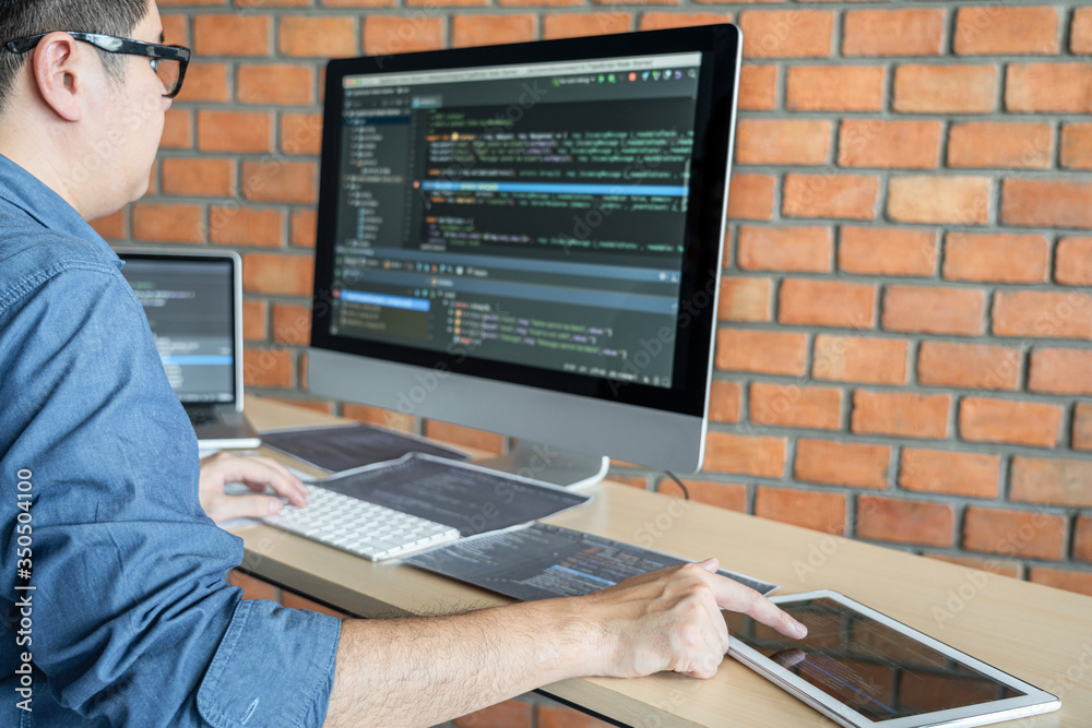 Poster Young Professional programmer working at developing programming and website working in a software develop company office, writing codes and typing data code, Programming with HTML, PHP and javascript
