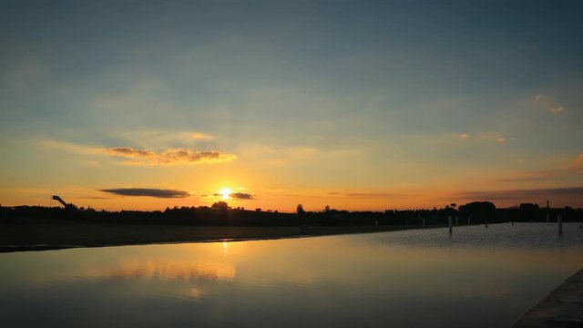Beautiful sunset timelapse with reflections in the pound water and fantastic light