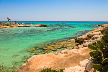 Mediterranean coast with a rocky coast and turquoise sea and people
