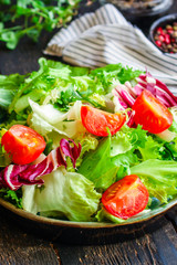 Healthy salad, leaves mix salad (mix micro greens, cucumber, tomato, onion, other ingredients) keto or paleo diet. food background copy space 