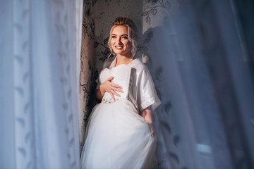 morning of the bride.Woman trying on a wedding dress.