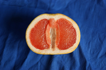 Vagina, clitoris and labia symbol. Grapefruit looks like a vagina (vulva), with the clitoris and labia. Female genitalia concept