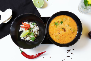 Tom Kha. Spicy spicy Asian soup with eggplant, chicken, mushrooms, lemongrass, served with rice and cilantro
