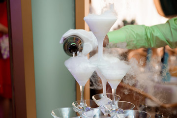 A lot of wine glasses with a cool delicious champagne or white wine at the bar. Alcohol background.