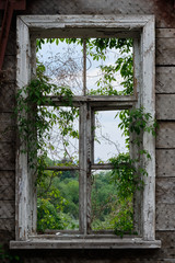 Old window in a ruined house overlooking the city of Kiev Ukraine