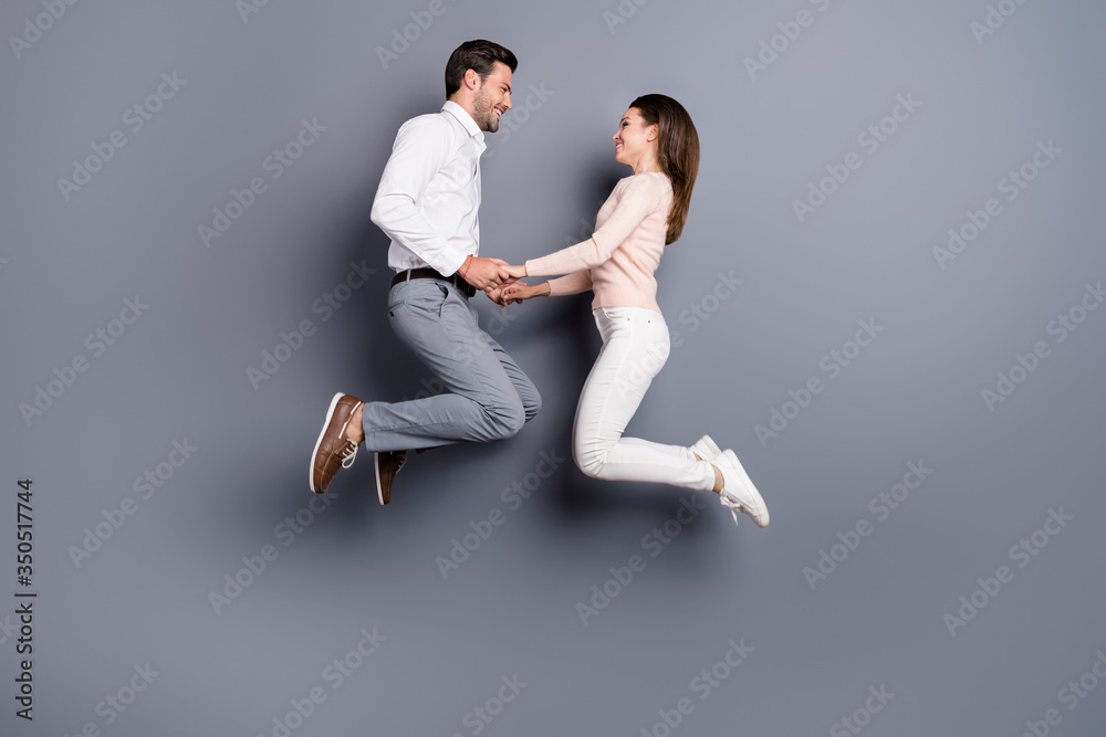 Wall mural Full length profile photo pretty lady handsome guy couple in love hold arms romantic feelings spend time together wear shirts pants shoes isolated grey color background