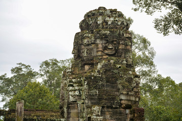Naklejka premium Stone faces carved in a tower of Bayon Temple, Cambodia. Ancient city of Angkor Thom near Siem Reap, Cambodia 