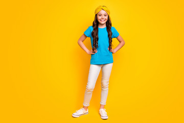 Full length photo of cute sweet girlish kid girl enjoy free time put hands waist wear good look clothes gumshoes isolated over shine color background