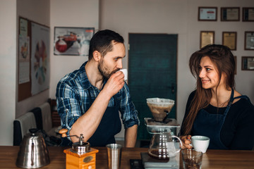 Man and woman tasting coffee in the style of 