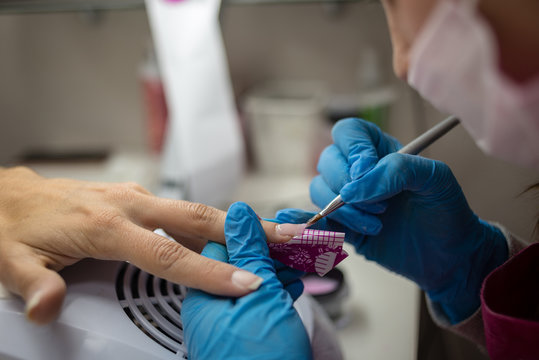 Personal Care. Close Up Detail Of Professional Hands Rebuilding Nails With Special Gel And Tool. Professional Manicure Salon.