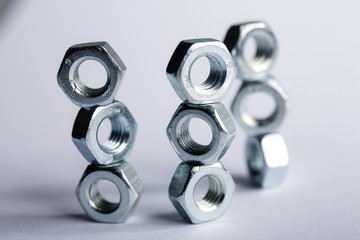 macro shot Metal nuts laid out in the shape of a figure. Imitation of honeycombs. Repair Concepts
