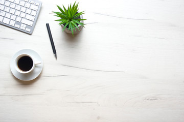 White desk office with laptop, smartphone and other work supplies with cup of coffee. Top view with copy space for input the text. Designer workspace on desk table essential elements on flat lay